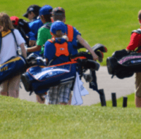 Kids carrying golf bags